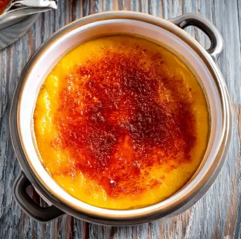 Crème brûlée and custard in bowls for comparison