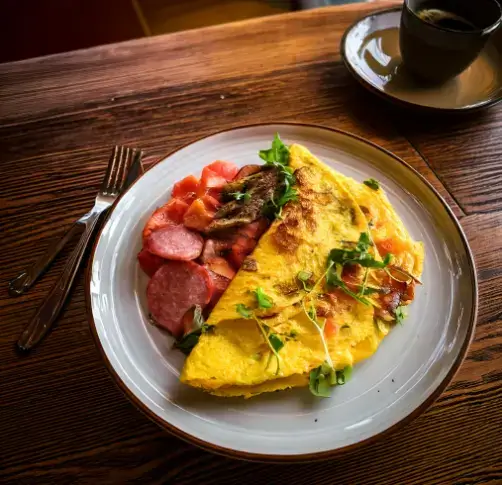 A variety Omelette filled with different meats like ham, bacon, sausage, and chicken, showcasing versatile and flavorful options for breakfast