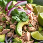 Close-up of Mexican Tuna Salad in a bowl with avocado, tuna, cilantro, and lime