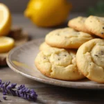 Freshly baked Lemon Lavender Cookies on a plate with lemon slices and lavender sprigs